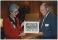 Photograph: [Rose Marie Wilkinson accepting a photo from Dr. Robert James Speer]