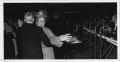 Photograph: [Couple dances near stage at 1988 North Texas Alumni Homecoming Dance]