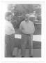 Primary view of [Two Men Visiting in Gonzales, Texas]