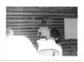 Photograph: [Hispanic Man Teaching in a Log Cabin]