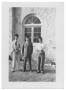 Photograph: [Three Young Men Standing in Front of a Window Outside]