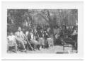 Photograph: [Group of Women Sitting on Chairs in the Shade]