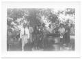 Photograph: [Group of People Standing in Front of a Tree]