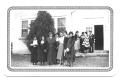 Photograph: [Hispanic Ladies Standing in Front of the Entrance to a Building]