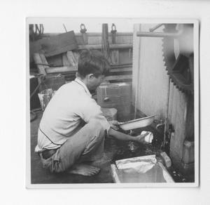 Primary view of object titled '[Cook Washes Dishes on the Evaleeta]'.