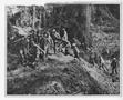 Photograph: [Marines Carry Stretcher Over Rugged Landscape]