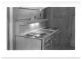 Photograph: [Side View of a Row of Stoves in a Kitchen]