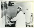 Thumbnail image of item number 1 in: '[Dr. Herman A. Barnett Works on a Patient Before Surgery]'.