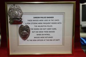Primary view of object titled '[Image of frame containing Junior Police Badges with description]'.