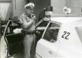 Photograph: [Arlington Police Officer Bill Taylor speaking over mobile radio, ca.…