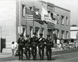 Primary view of [APD Color Guard marching in the Arlington Fourth of July Parade, late 1980s]