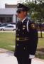 Primary view of [APD Honor Guard officer, Gary Krohn, standing at attention]