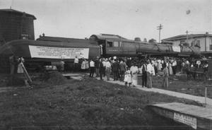 Primary view of object titled '[Group of people in front of a locomotive at Rosenberg, TX c. 1914]'.