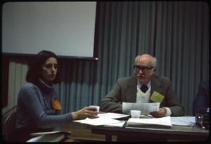 Primary view of object titled '[Biruta Kearl and Sam Whitten at a Meeting]'.