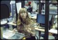 Photograph: [Woman Works in Library Office Space]