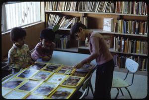 Primary view of object titled '[Children Organize National Geographic Magazines]'.