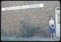 Photograph: [Woman Stands by the Leon County Library Sign]