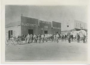 Primary view of object titled '[Blacksmith shop with buggy out front]'.