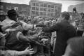 Photograph: [President Kennedy greeting crowd outside of Hotel Texas]