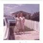Primary view of [Lillie Abercrombie with unidentified woman by picket fence]