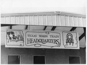 Primary view of object titled 'Texas Sesquicentennial Wagon Train Headquarters Sign in Irving'.