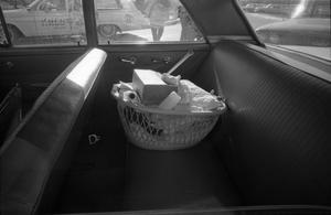 Primary view of object titled '[Basket full of items in a car parked at Parkland Hospital]'.