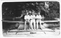 Primary view of [George A. Hill, Jr. with sitting with unidentified men near fountain]