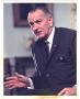 Primary view of [President Lyndon Baines Johnson 3/4 length seated portrait speaking and gesturing with hand]