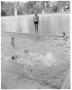 Photograph: [Man standing at edge of Deep Eddy pool while instructing swimmers in…