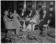 Photograph: [A group of people sitting around a table at the Perry Brooks Hotel]