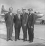 Photograph: [Four unidentified men in front of Trans Texas Airways aircraft]