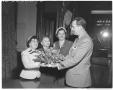 Photograph: [Governor Allan Shivers receiving flowers from three women]