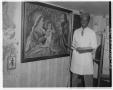 Photograph: [Charlie Clifton Cain Jr. standing next to painting]
