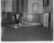 Photograph: [A man cleaning up the interior of the Capital building]