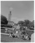 Photograph: [Students sitting in front of U.T. water fountain]