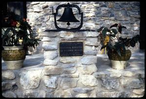 [Bell, Plaque, and Flower Vases on Stone Construction]