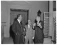 Photograph: [An unidentified man and Allen Russell conversing with John Wayne]