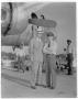 Photograph: [Two men in front of airplane]