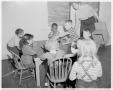 Photograph: [Children having snacks at a table in a nursery]