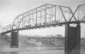 Thumbnail image of item number 1 in: '[Brazos Bridge in Rosenberg. People are gathered on the bridge.]'.