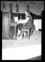 Photograph: [Photograph of a Woman Playing the Piano]