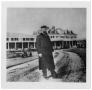 Photograph: [Man in Front of Old Sabine Hotel]