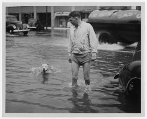 Primary view of object titled '[Man and Dog in Flood Waters]'.