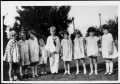 Photograph: [Nine children standing and holding hands on the Dyer Moore lawn]