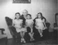 Photograph: [Marie Bachman Guenther sitting with three great grandchildren]