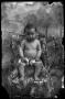 Photograph: [Diapered baby posed on a chair]