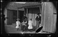 Photograph: [Woman and two men with three children]