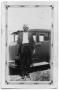 Photograph: [Dowl Chambliss standing by car]