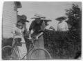 Photograph: [Women with a toddler on a bike]