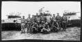 Photograph: [Soldiers pose in front of military tank]
